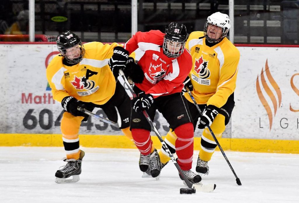 Three blind hockey players racing for the puck