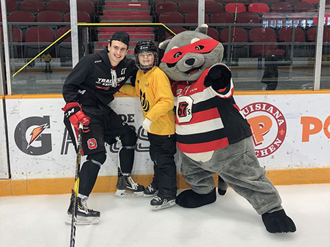 Mascot with coach and blind hockey player